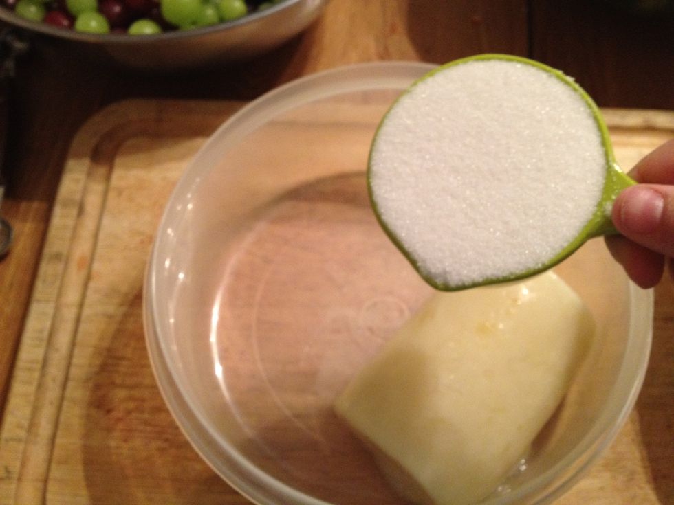 Add the frozen mix to a bowl along with 1/2 cup of sugar.