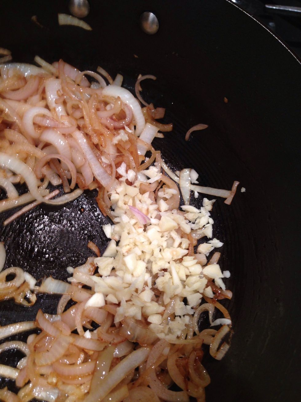 Add the garlic and fry until the onion starts to brown