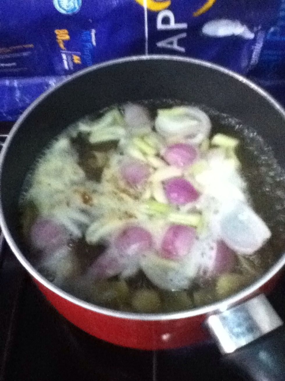 Add the garlic, onion, galangal and lemongrass in the boiling water and let it continue to boil for about 3 mins. (You could use chicken stock for better taste)