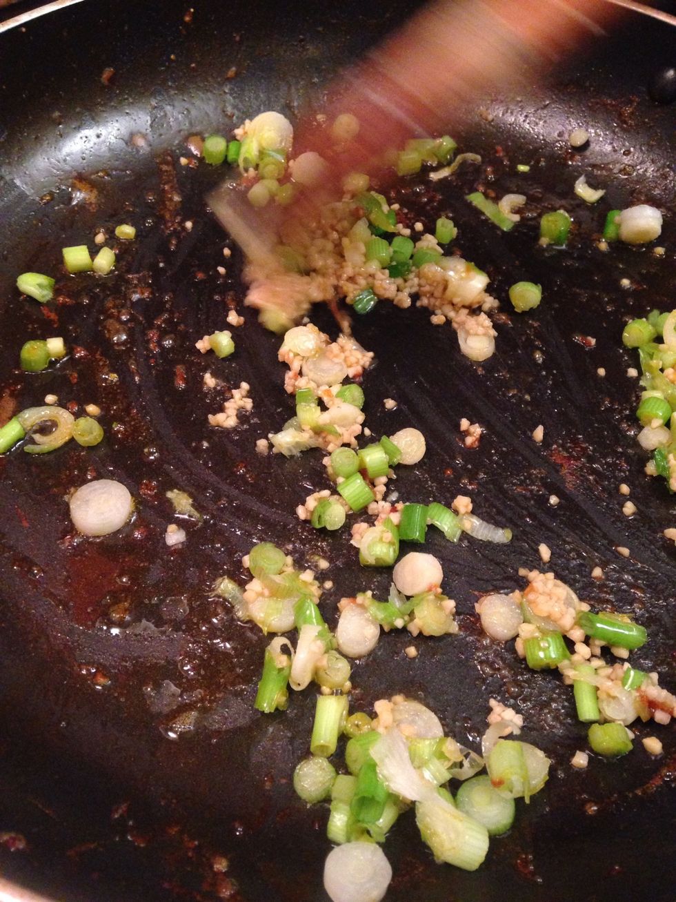 Add the garlic, scallions and a seasoning of salt