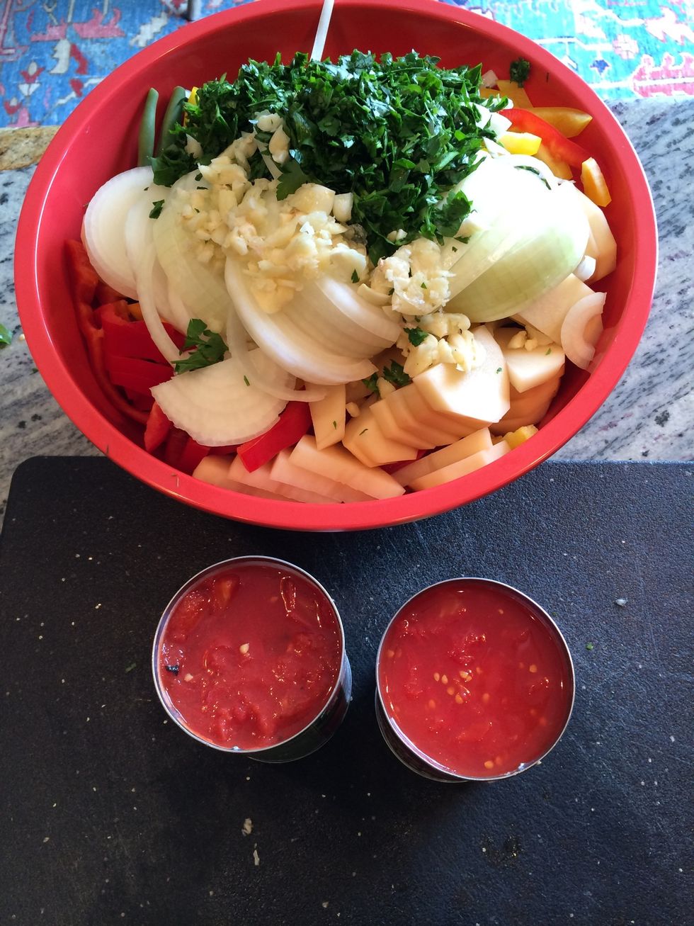 Add the garlic to the bowl. Then add the tomato, the olive oil, the salt, the black ground pepper and the red chilly flakes.