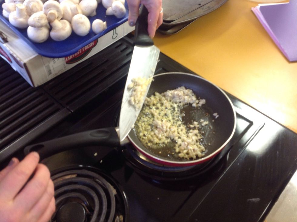 Add the garlic to the mushroom stems and be sure to stir constantly. If the food starts to burn, remove it from the burner and adjust the heat as needed. Do not burn the filling!