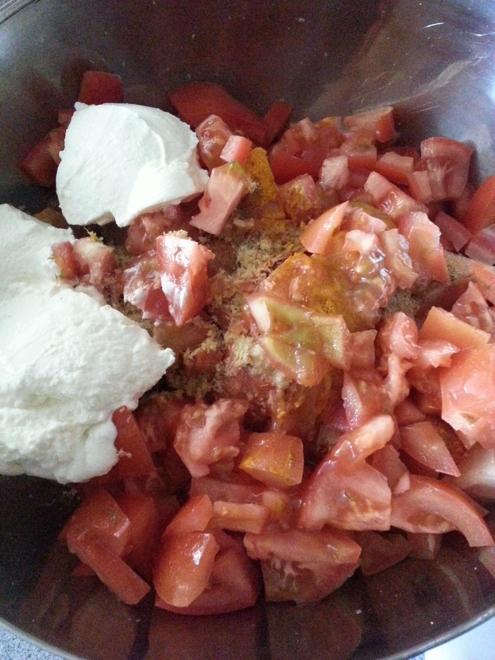 Add the ginger garlic paste, tomatoes and yoghurt to the chicken.