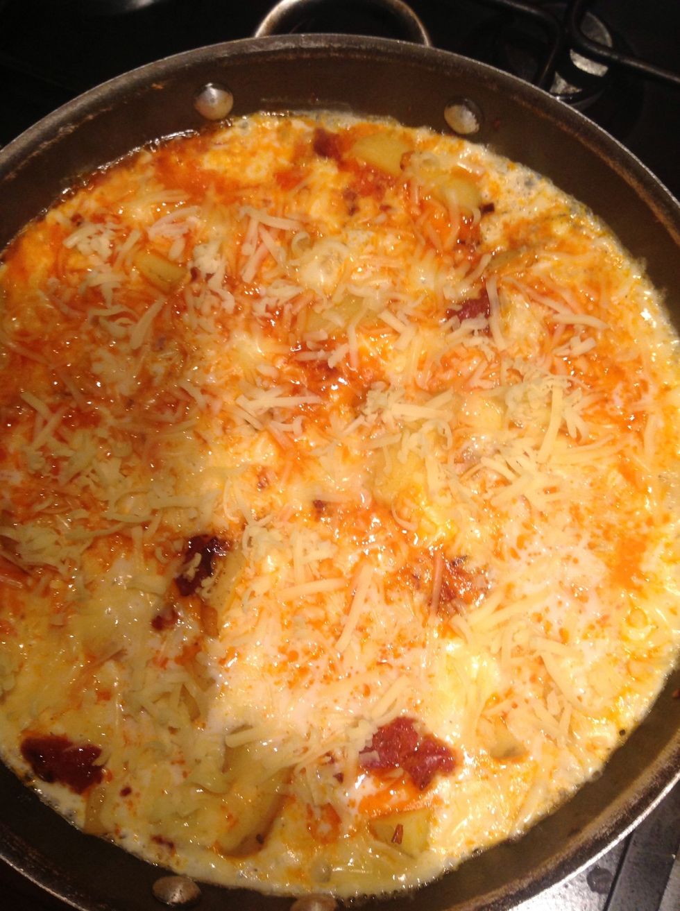 Add the grated cheese to the pan