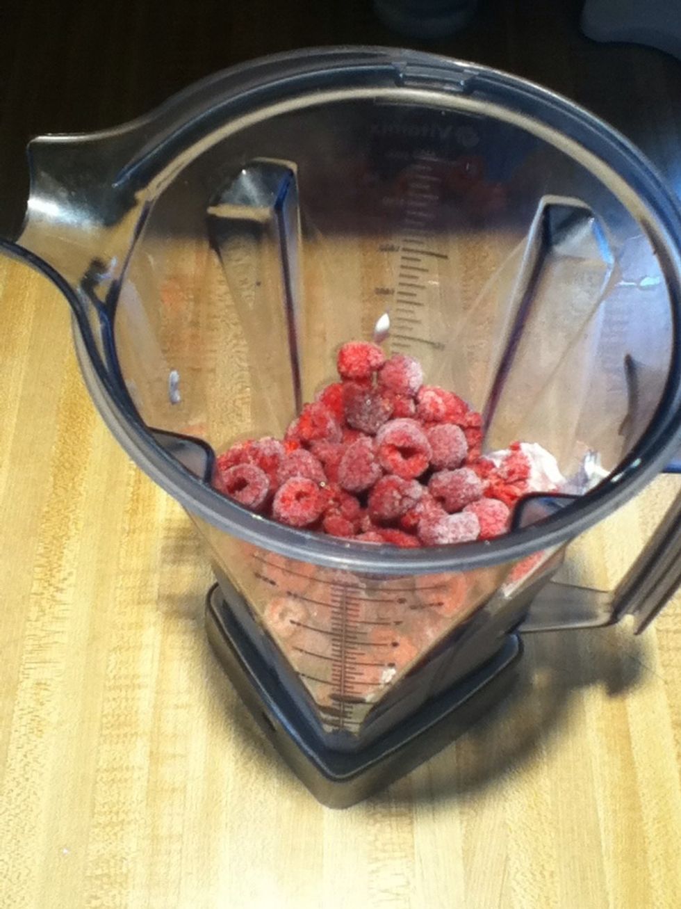 Add the Greek yogurt, raspberries, an vanilla to your blender or food processor.