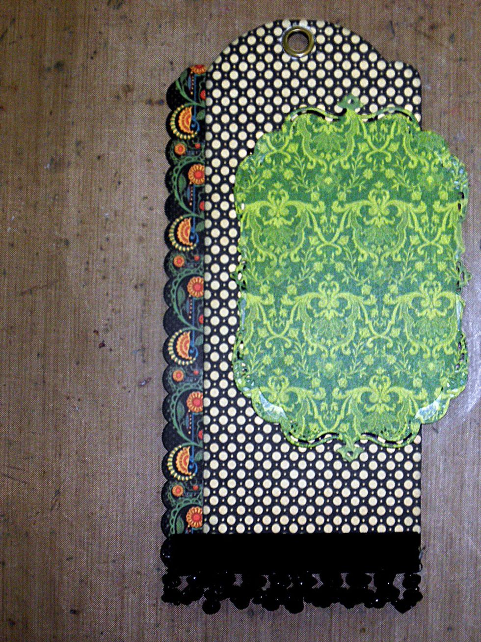 Add the green diecut frame to the right side of the tag about 2.5" from the bottom.