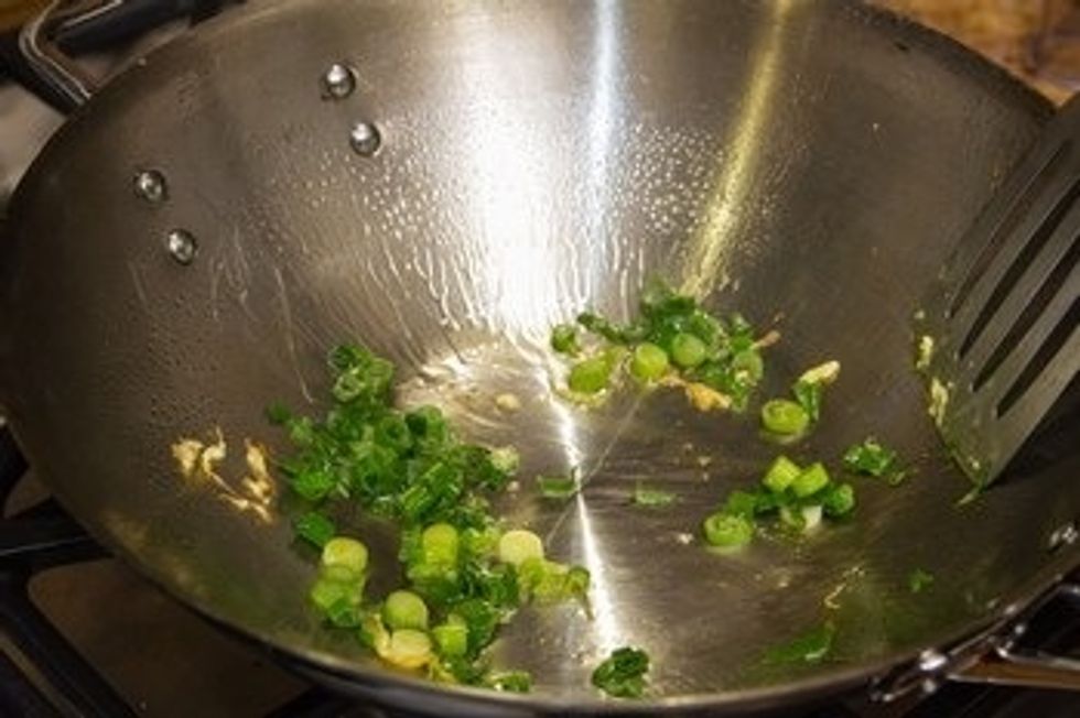 Add the green onions and stir fry until nicely coated with oil.