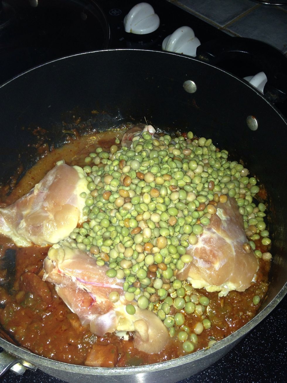 Add the green pigeon peas, water, the noodles or rice, babe carrots and the package of "sazon". Add salt and pepper to taste and stir occasionally. Let it cook for 30-35 mints..