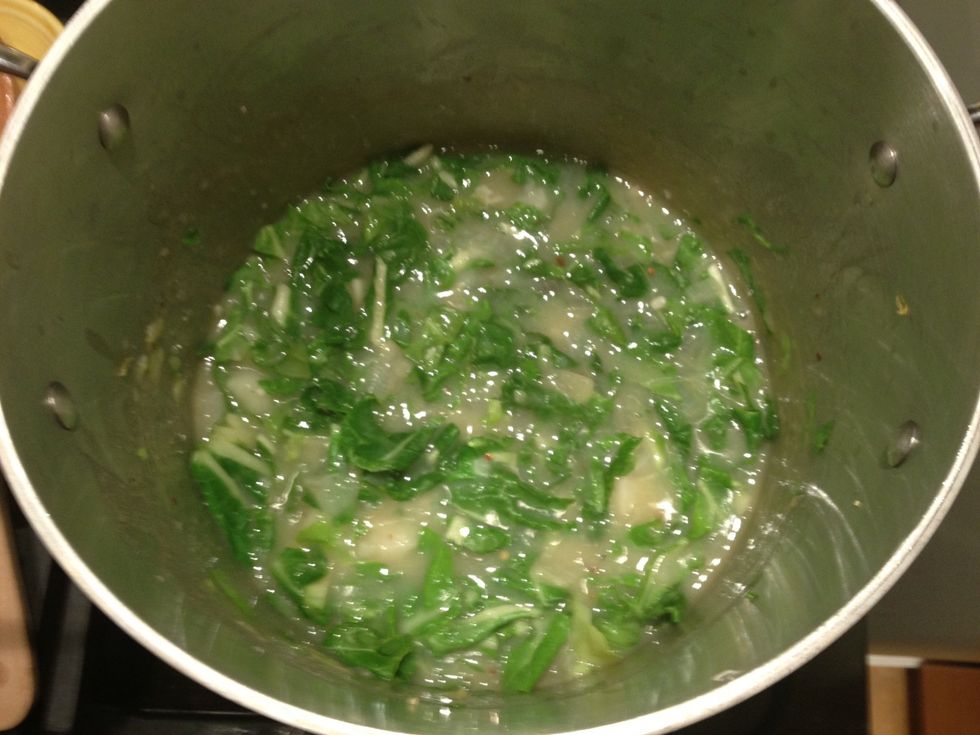 Add the greens to the soup, and cook down for a minute or two.