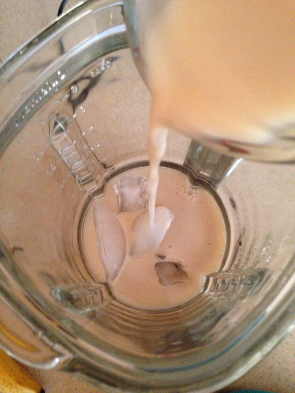 Add the handful of ice in the blender, then pour in the Almond Milk.   You can use sweetened, unsweetened, vanilla, plain, chocolate, or regular milk... Whatever floats your boat.