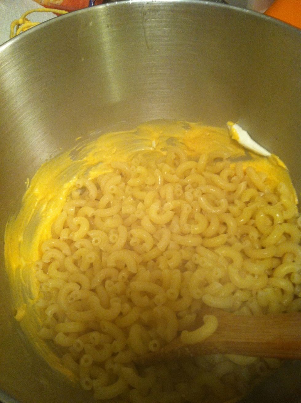 Add the hot macaroni to the cheese sauce.