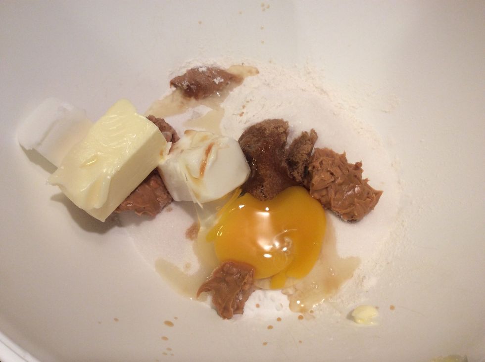 Add the ingredients to the large bowl;4 tbs butter, 4 tbs Crisco Shortening, 2 cups flour, 1 cup sugar, 1/4 cup brown sugar, 1/4 cup chunky peanut butter, 2 eggs, 1/2 tsp vanilla, 1/2 tsp baking soda.