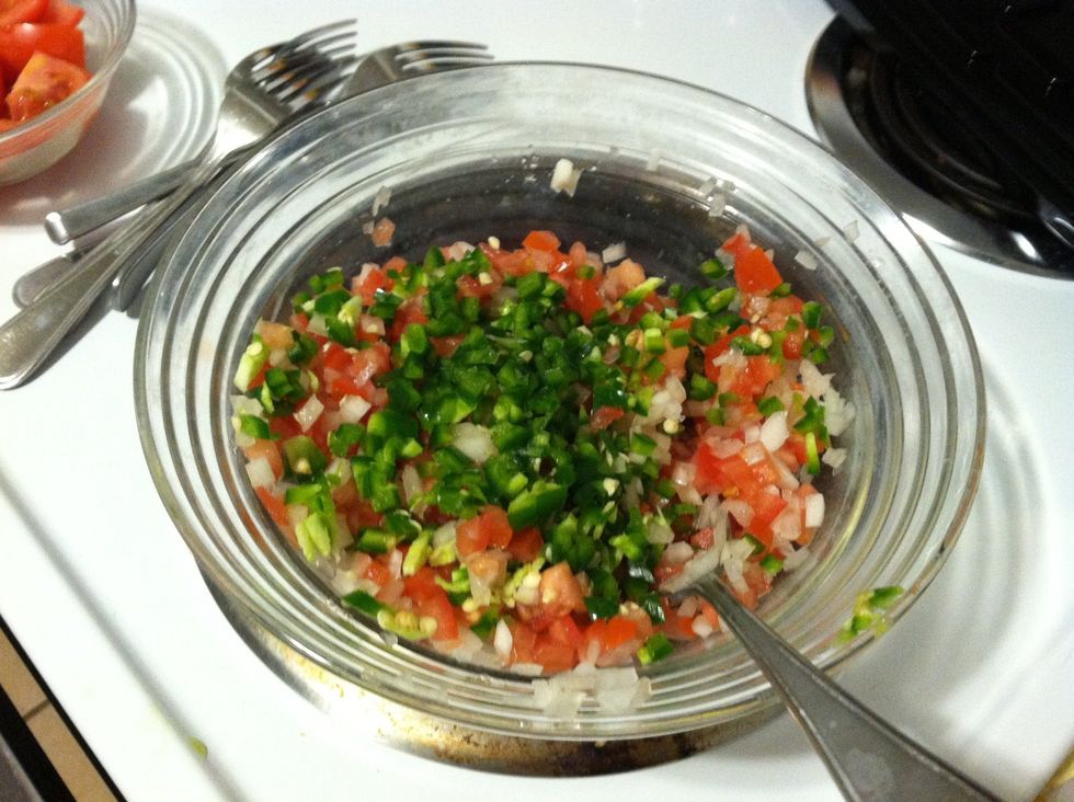 Add the jalape\u00f1o. Mix it up. At the point I like to taste the salsa to see how hot the jalape\u00f1os are. If they're super hot I usually add more tomatoes. If they're not spicy at all I usually add more.