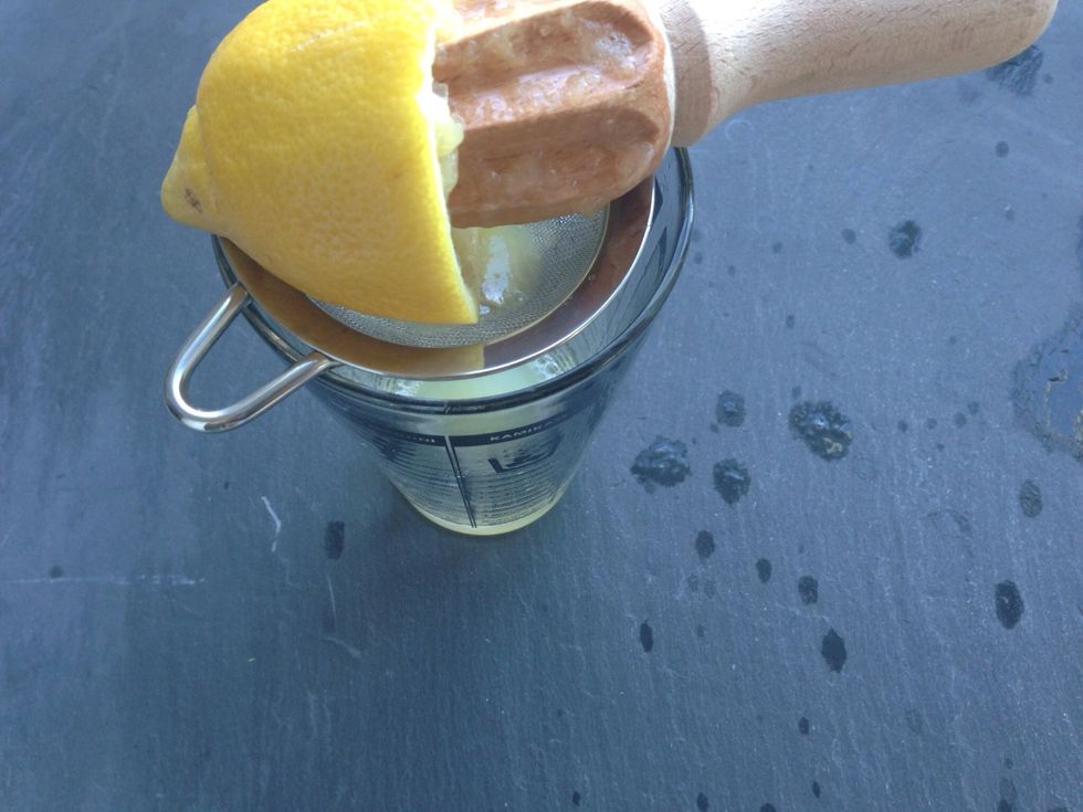Add the juice of half a lemon and 1/4 cup of the Rosemary-Basil Infused Simple Syrup in a glass.