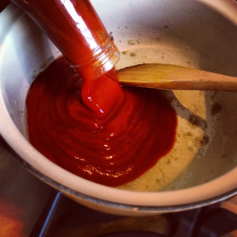 Add the ketchup, mix with the garlic and then simmer gently.