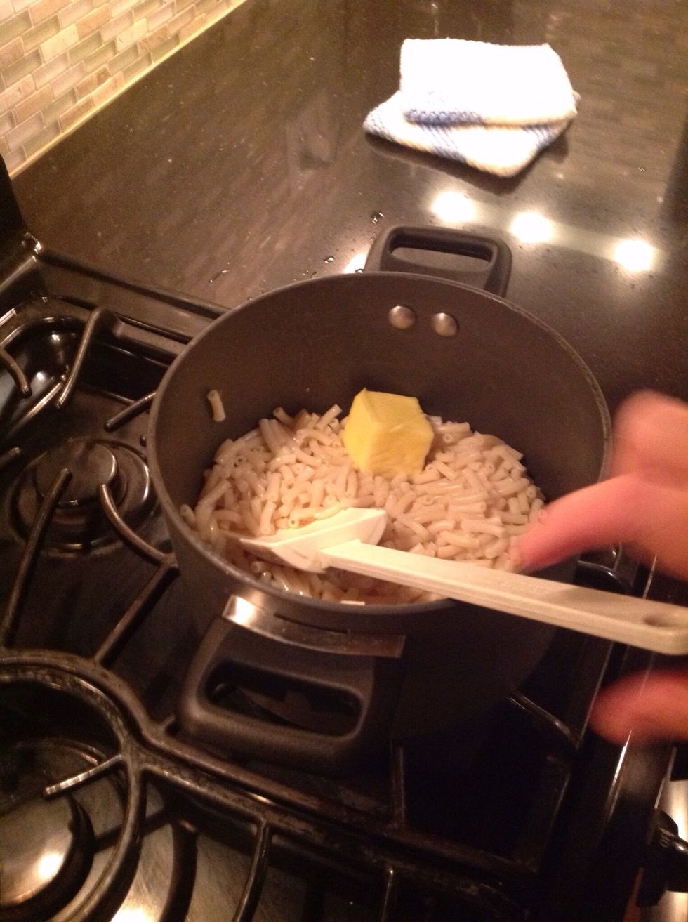 Add the knob of butter into the macaroni.