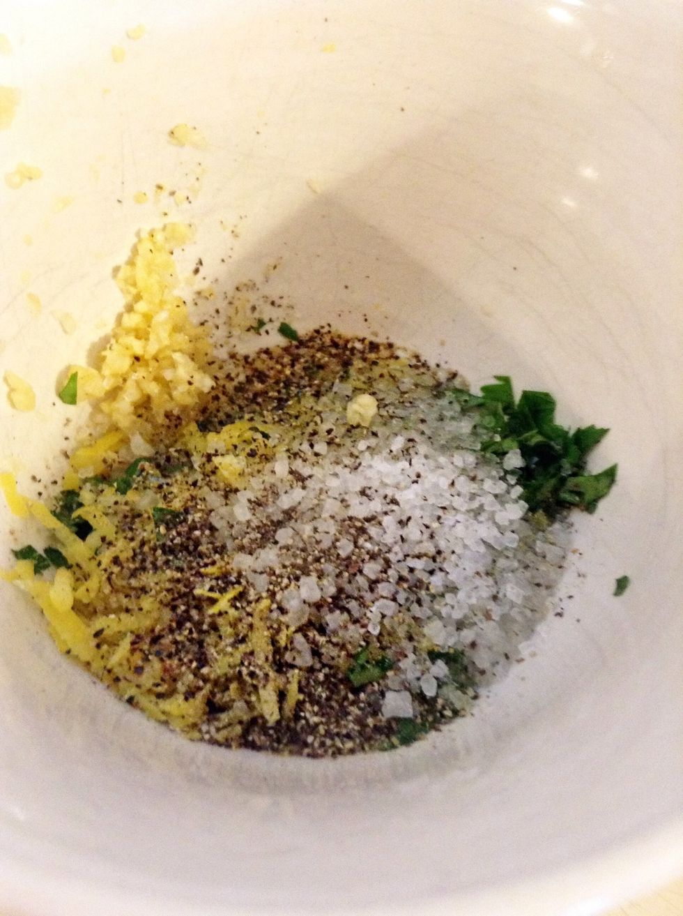 Add the lemon juice, finely cut lemon peel, salt and pepper to the garlic and parsley bowl.