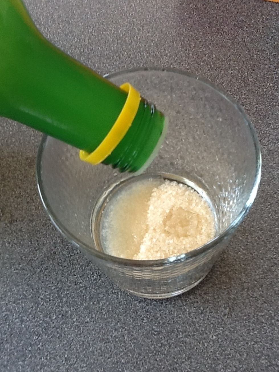 Add the lemon juice to the sugar so it covers it.