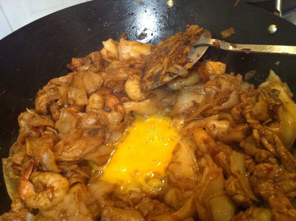 Add the lightly whisked egg. Allow it to set a little before mixing it through.