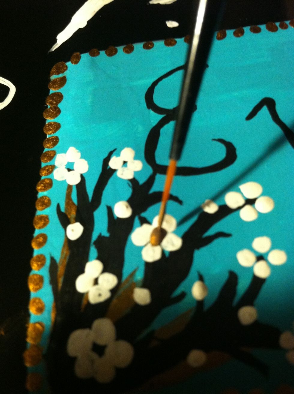 Add the little gold dots in the middle of the flowers and around the stems.