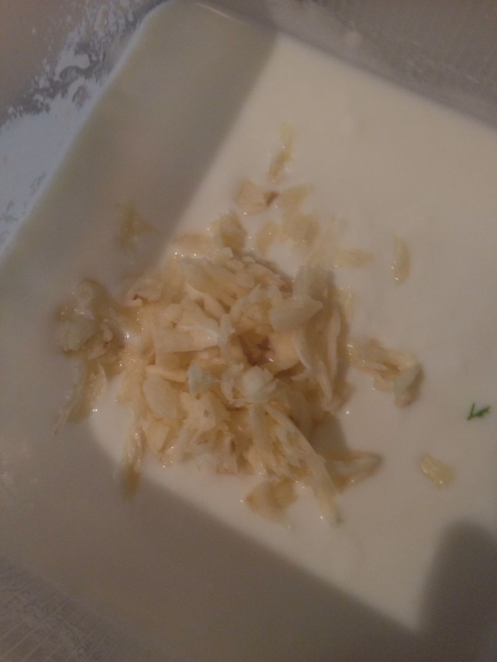 Add the mashed garlic into the yoghurt.