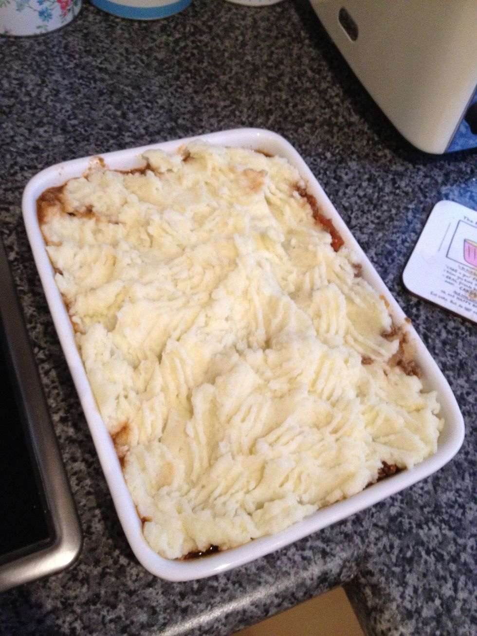 Add the mashed potatoes to the top and use a fork to fluff. I added a sprinkle of grated mature cheese on the top.