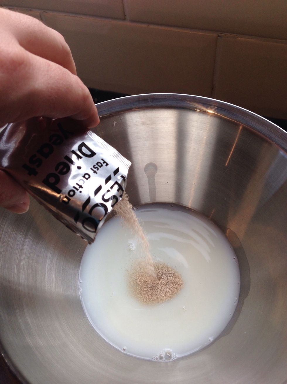 Add the milk and water to the bowl then whisk in the yeast