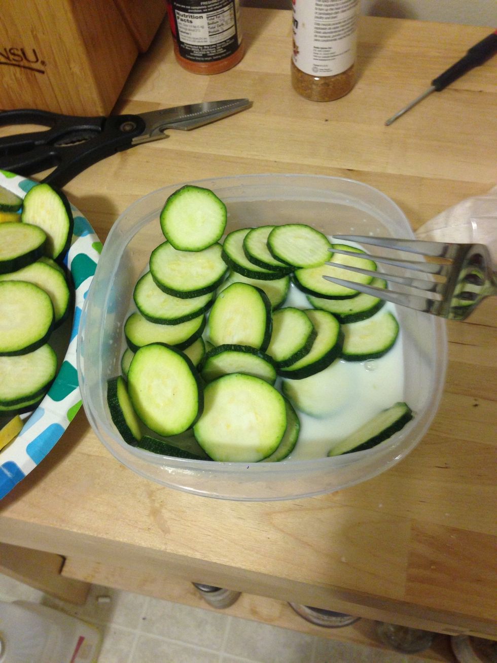 Add the milk to a separate container and soak the squash. You can alternately use egg at this step  it holds together the batter a bit better.