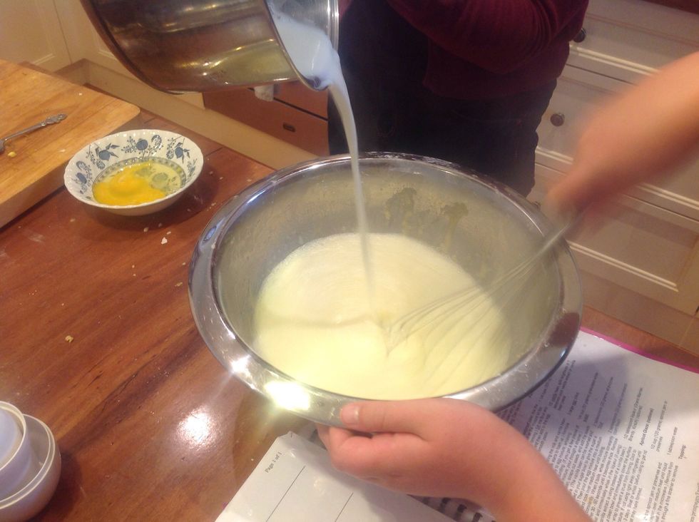 Add the milk to the mixture while constantly whisking to prevent it curdling.
