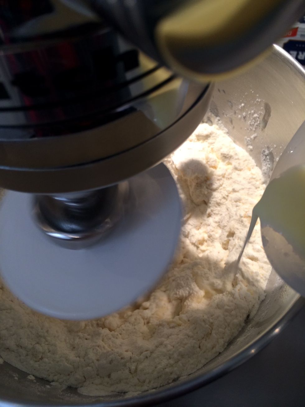 Add the milk while the mixer is running on low