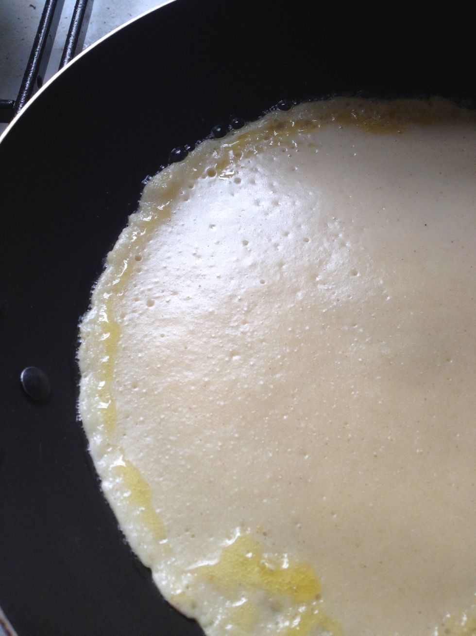Add the mix into the pan and spread around the pan until it covers every edge. When little holes start to pop out then the pancake is ready to flip.