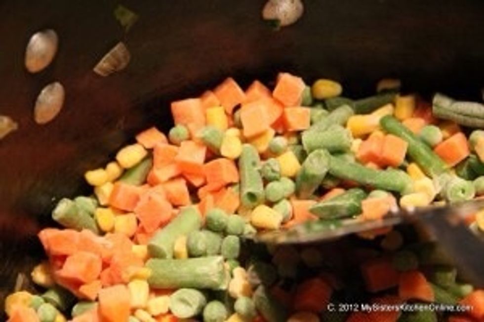Add the mixed vegetables to the onion and cabbage mixture. Saut\u00e9 two minutes more until veggies are hot.