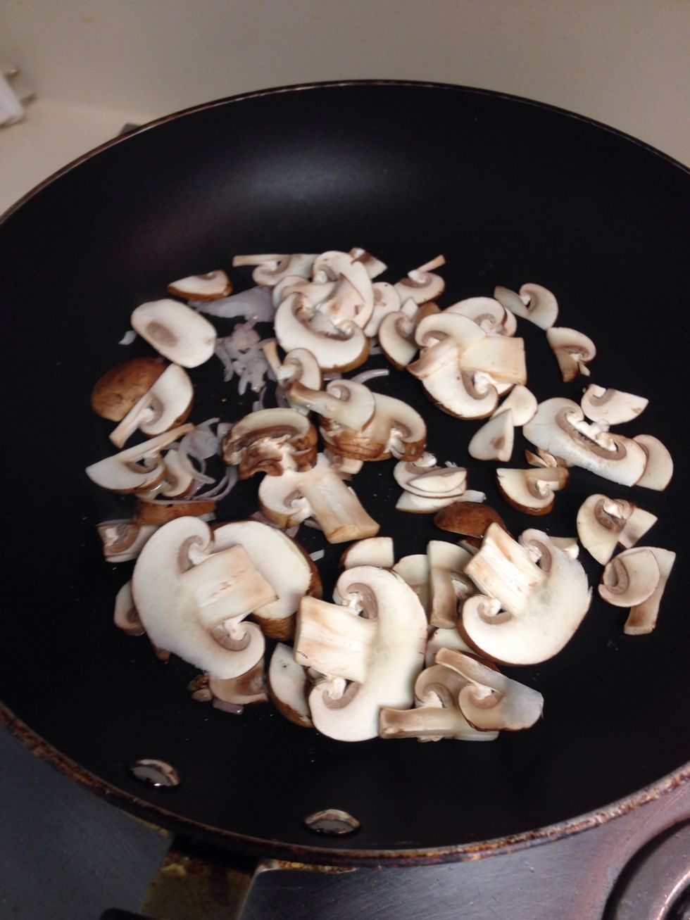 Add the mushrooms. I like to add as a splash of water to help it cook evenly and prevent the mushrooms from burning.