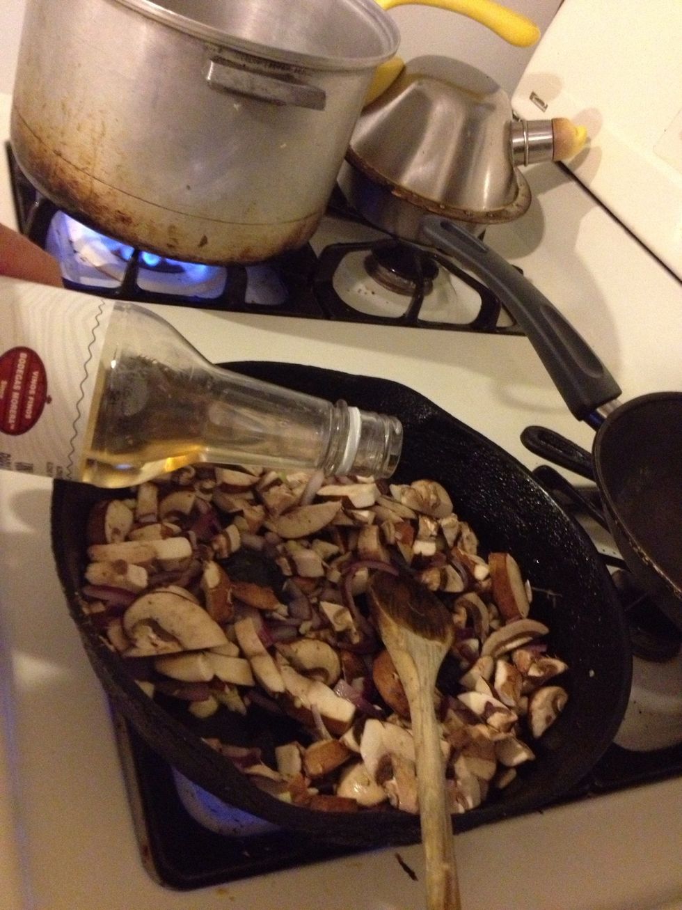 Add the mushrooms the the pan as well the cooking wine.
