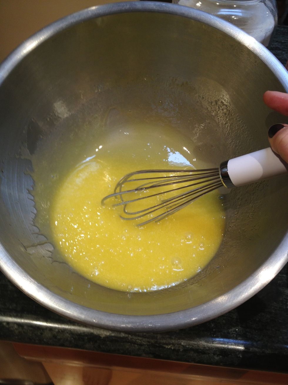 Add the olive oil, and whisk until combined. It will turn lighter in color and begin to thicken slightly. Then whisk in the almond and vanilla extracts.