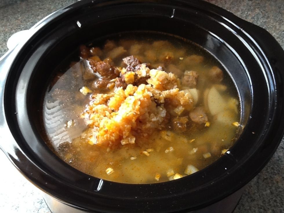 Add the onion, garlic, sausages, and chicken broth to the pot. Add a pinch of salt to flavor if desired, (highly recommended).