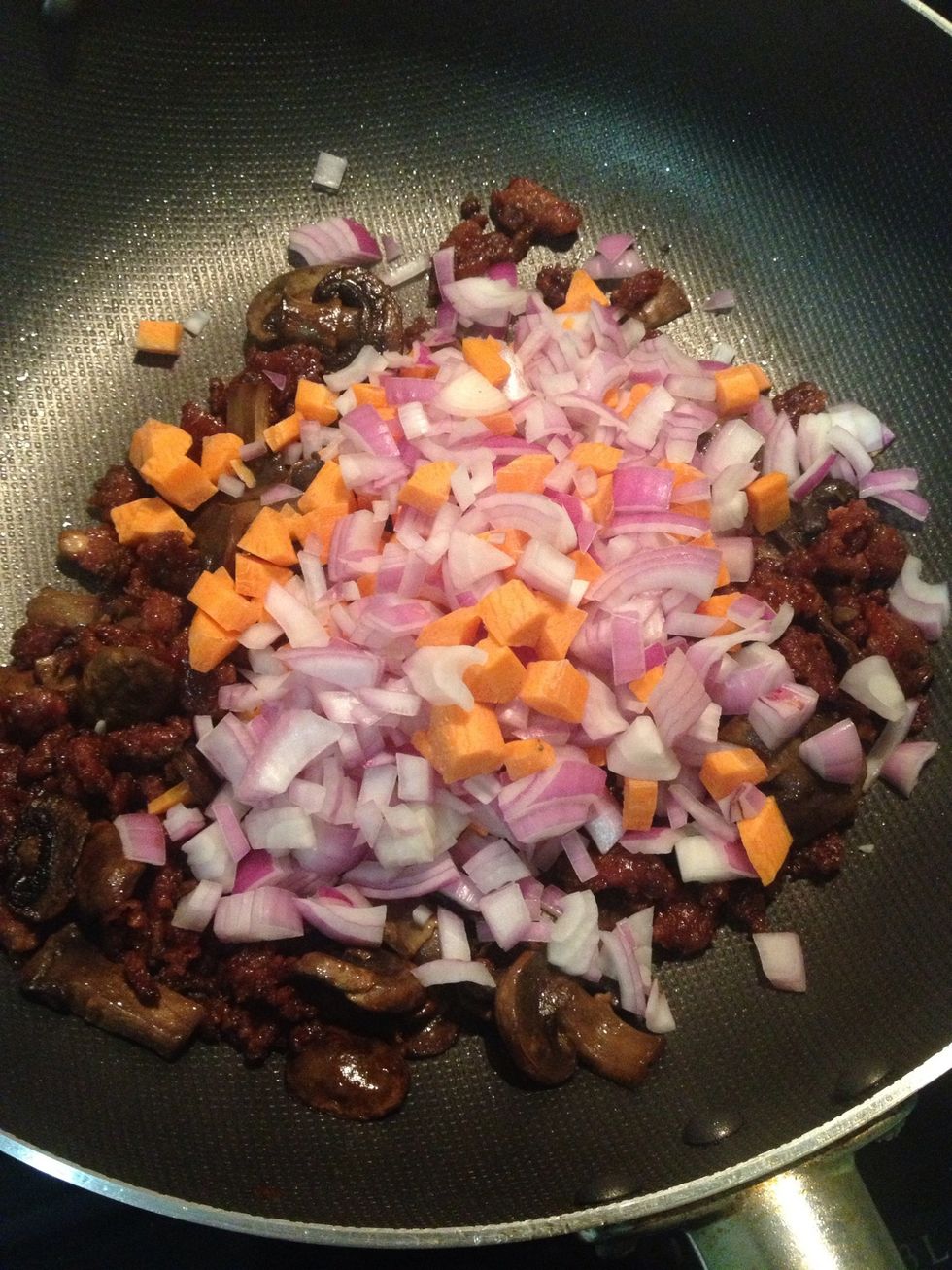 Add the onions and carrots in.