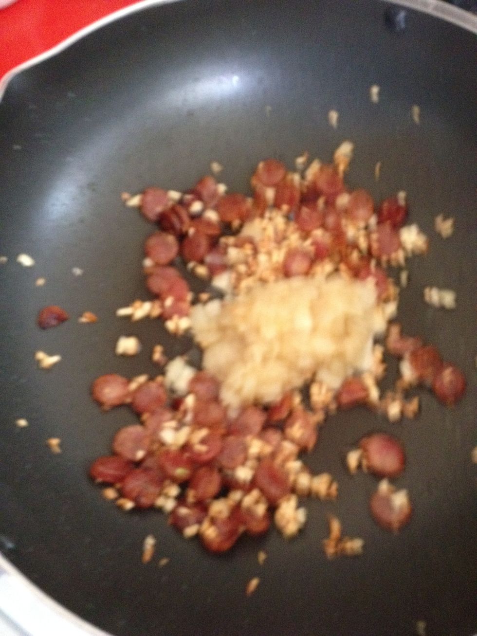 Add the onions and stir fry until the garlic starts to brown
