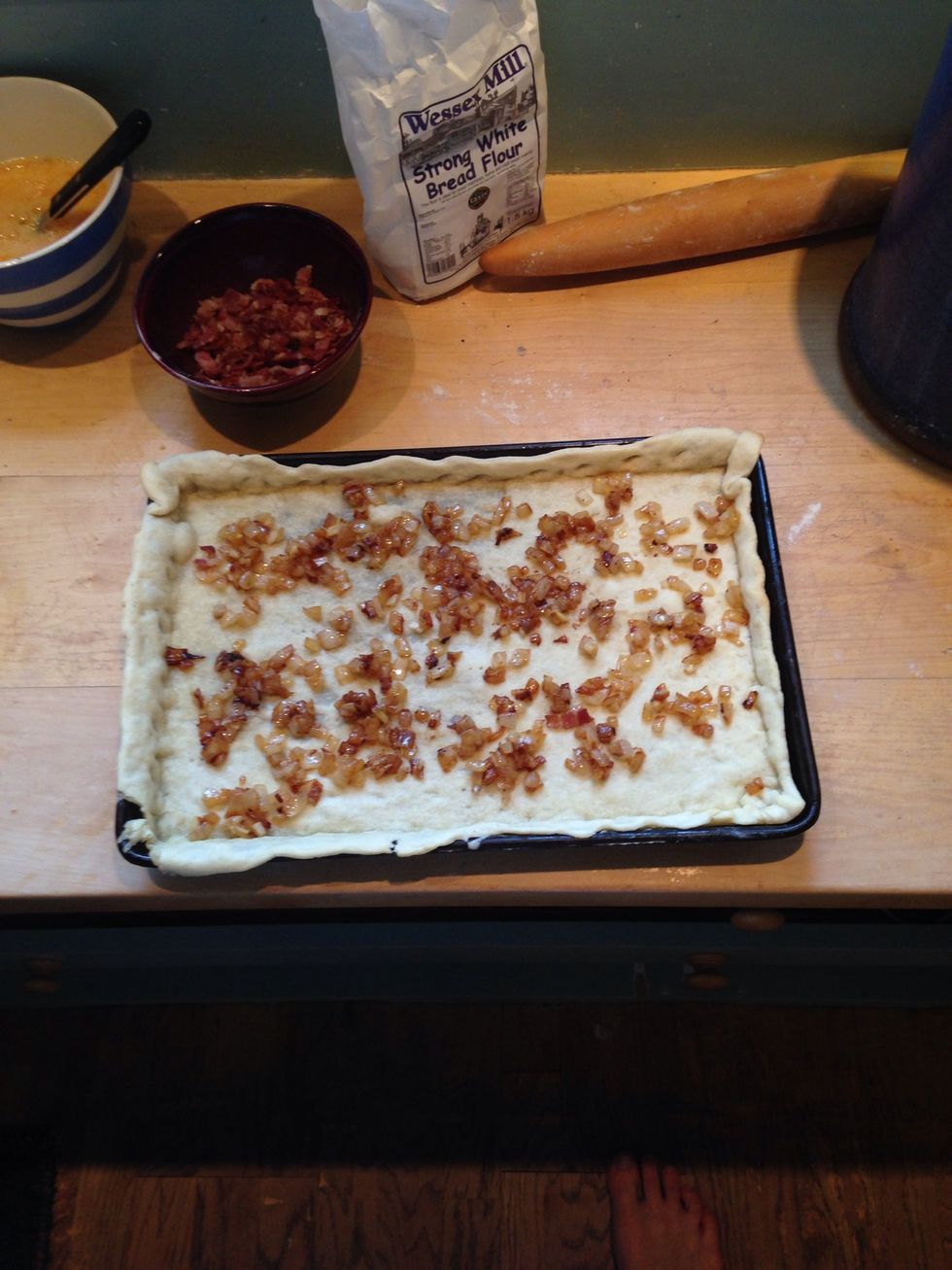 Add the onions to the heated pastry