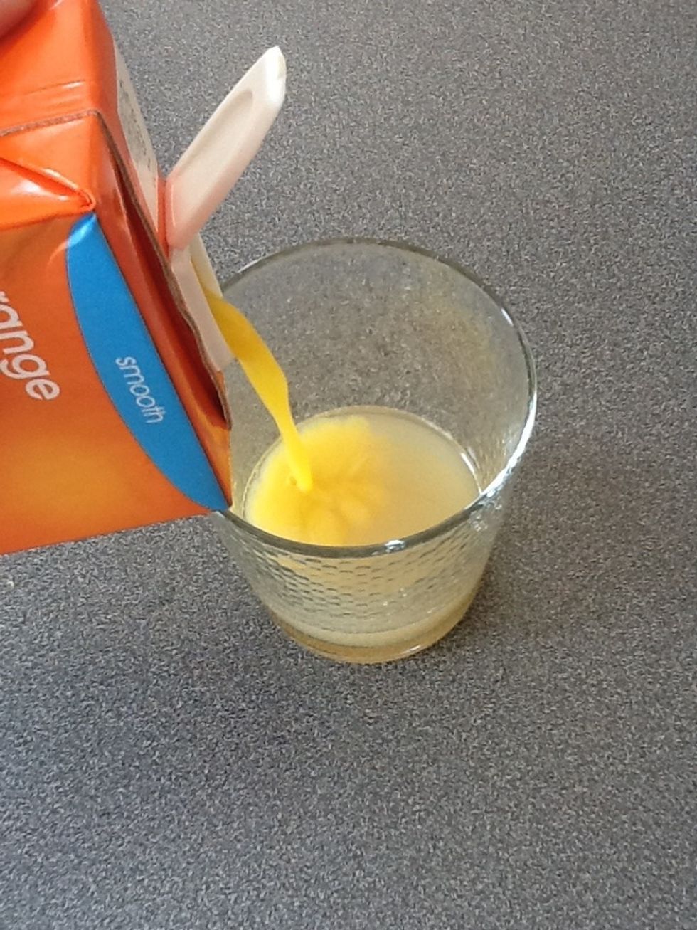 Add the orange juice so the drink comes half way up the glass.