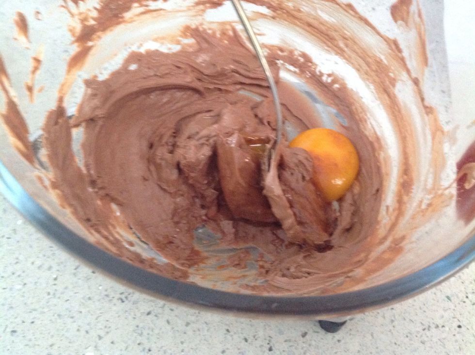 Add the other egg yolk to the milk chocolate and stir until combined. Once again, the mixture will become firm.
