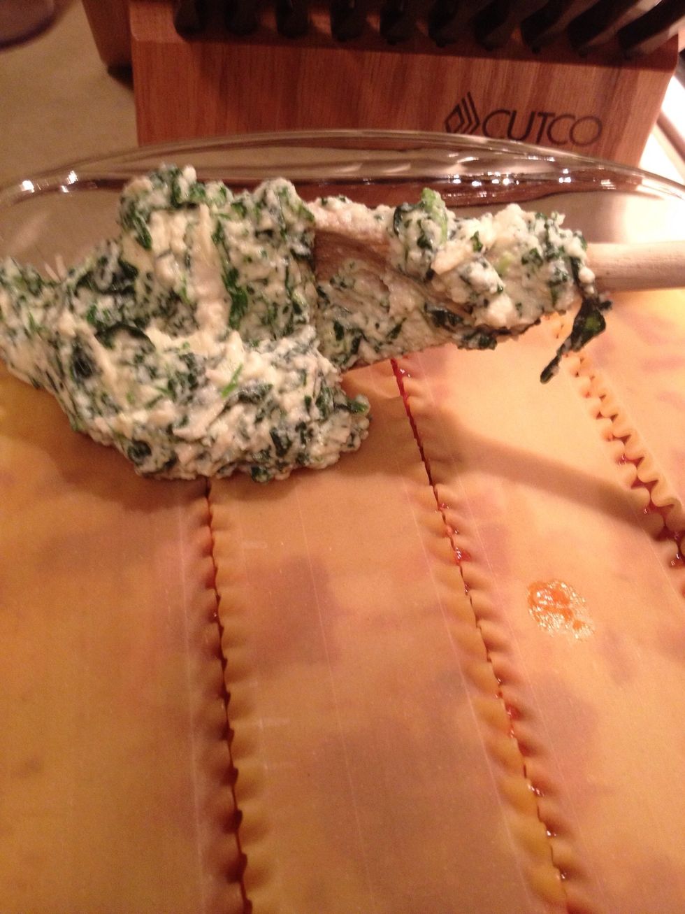 Add the other half of the ricotta mixture