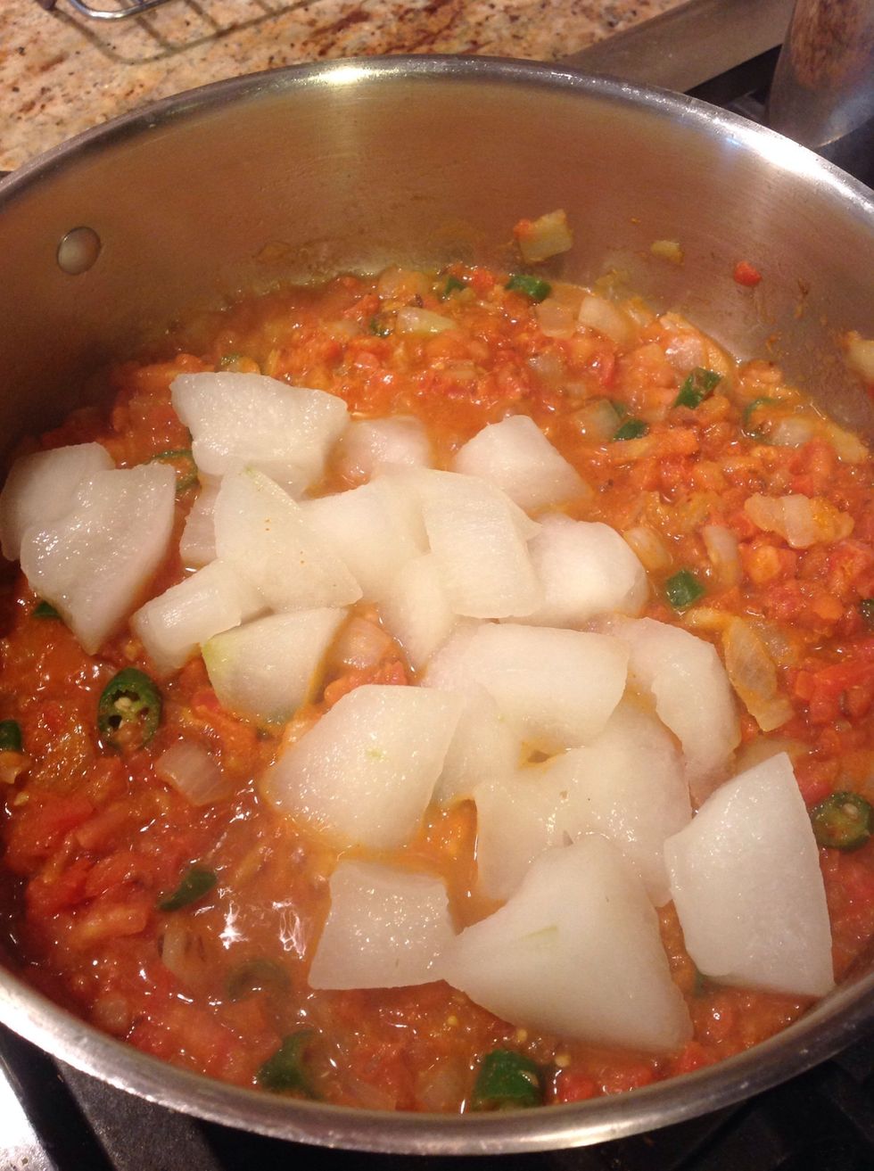 Add the partially cooked winter melon cubes and mix.  Add some salt according to taste.