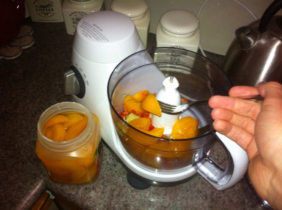 Add the peaches from the can (or tub in this case). You only want to add the fruit, but save the juice for later