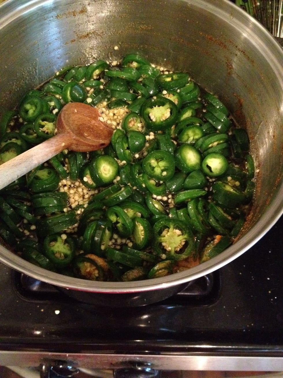 Add the pepper slices and simmer for exactly 4 minutes. Note: not all pepper slices will fit in the pot so do half for 4 minutes, remove and place in jars, and add the rest of the peppers to the pot.