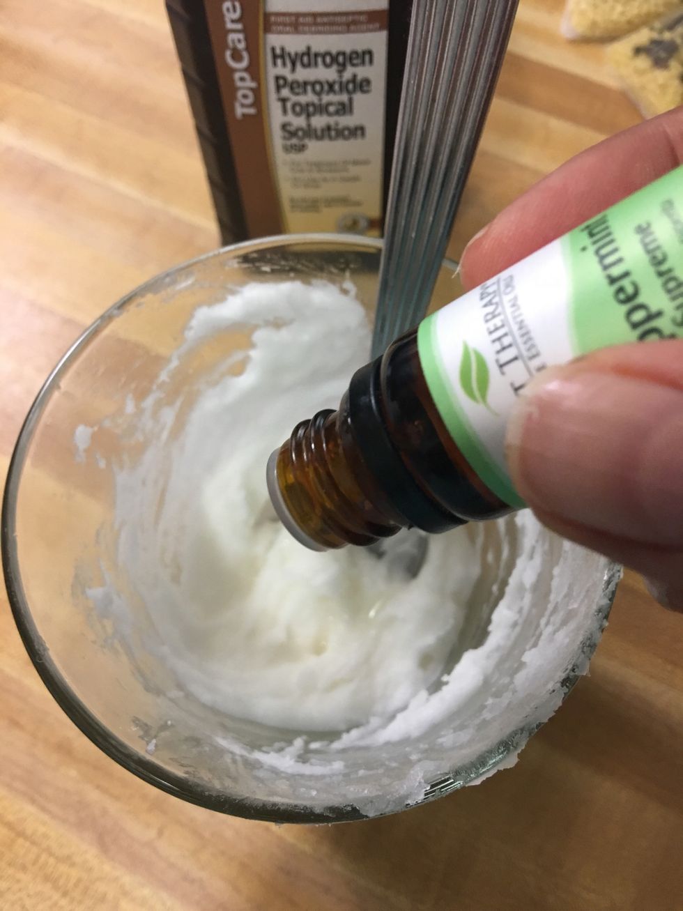 Add the peppermint and tea tree  essential oils. Mix thoroughly. If the consistency is too thin, add more baking soda. If it is too dry, add more hydrogen peroxide.