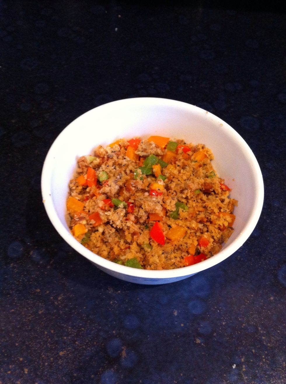 Add the peppers you grilled earlier to the breadcrumb mixture along with half a teaspoon of black pepper and stir well till it looks something like this... This will be the stuffing for the mushrooms
