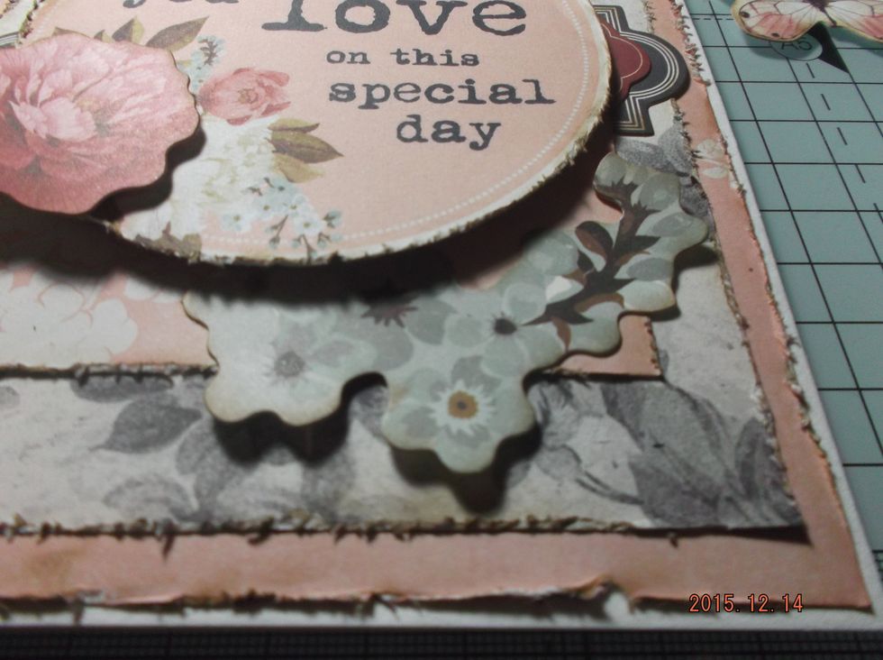 Add the pieces backed with cardboard and then slot under the flower die-cuts.
