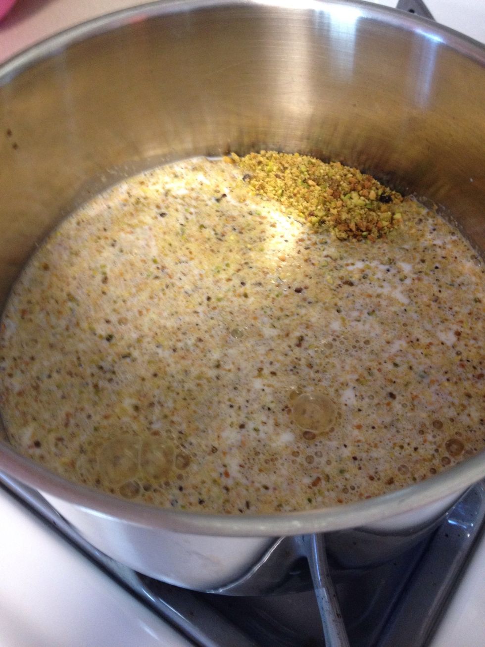 Add the pistachio and sugar mixture to the whole milk in a pot over medium heat, stirring frequently, until boiling