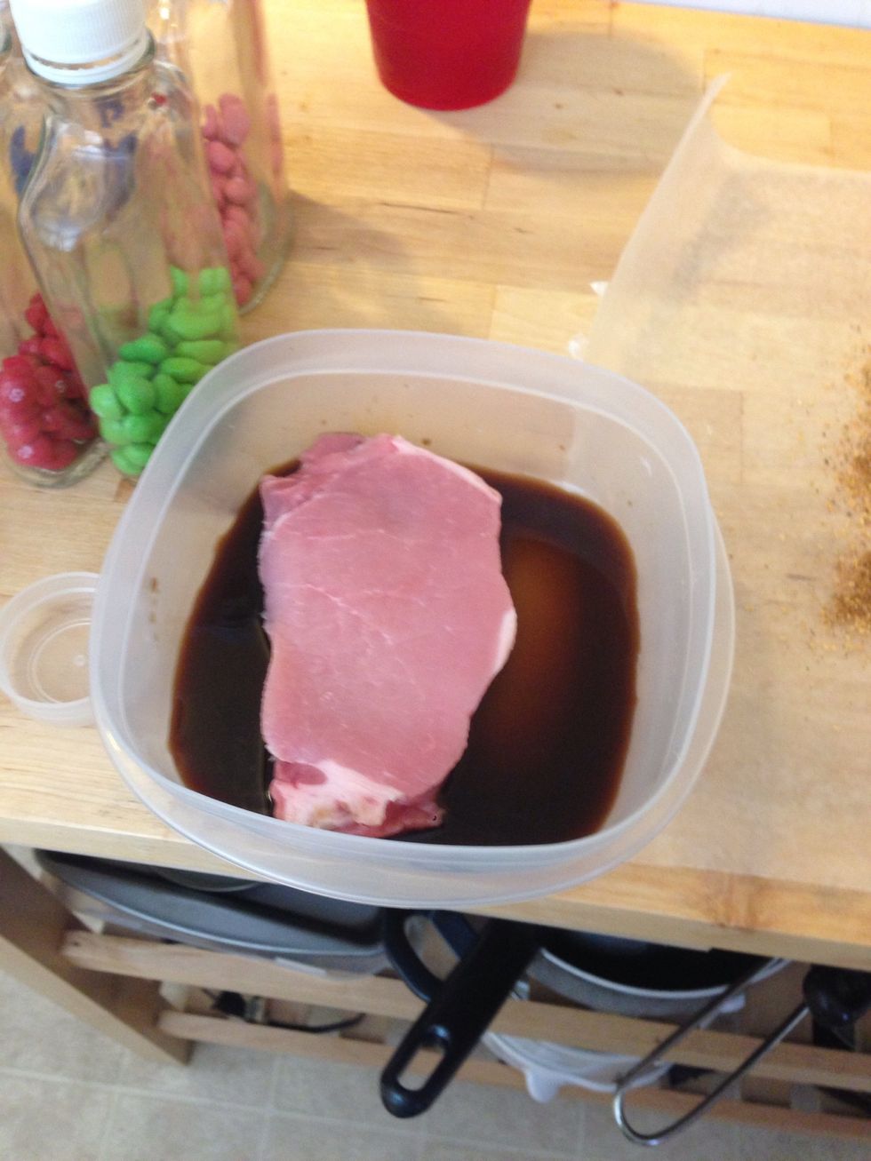 Add the pork to the container and soak both sides.